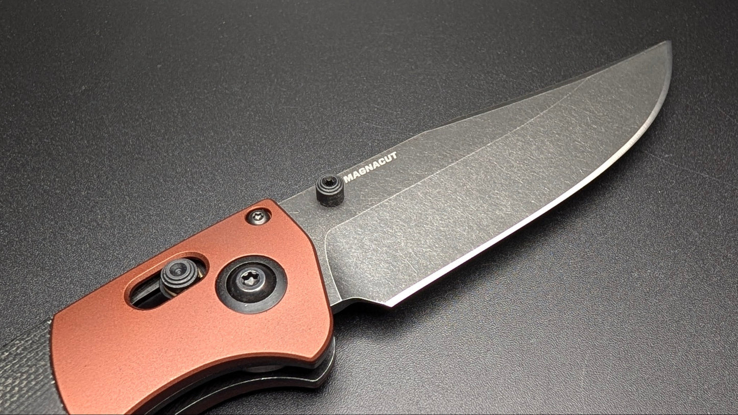 Folding knife with a copper handle on a black background