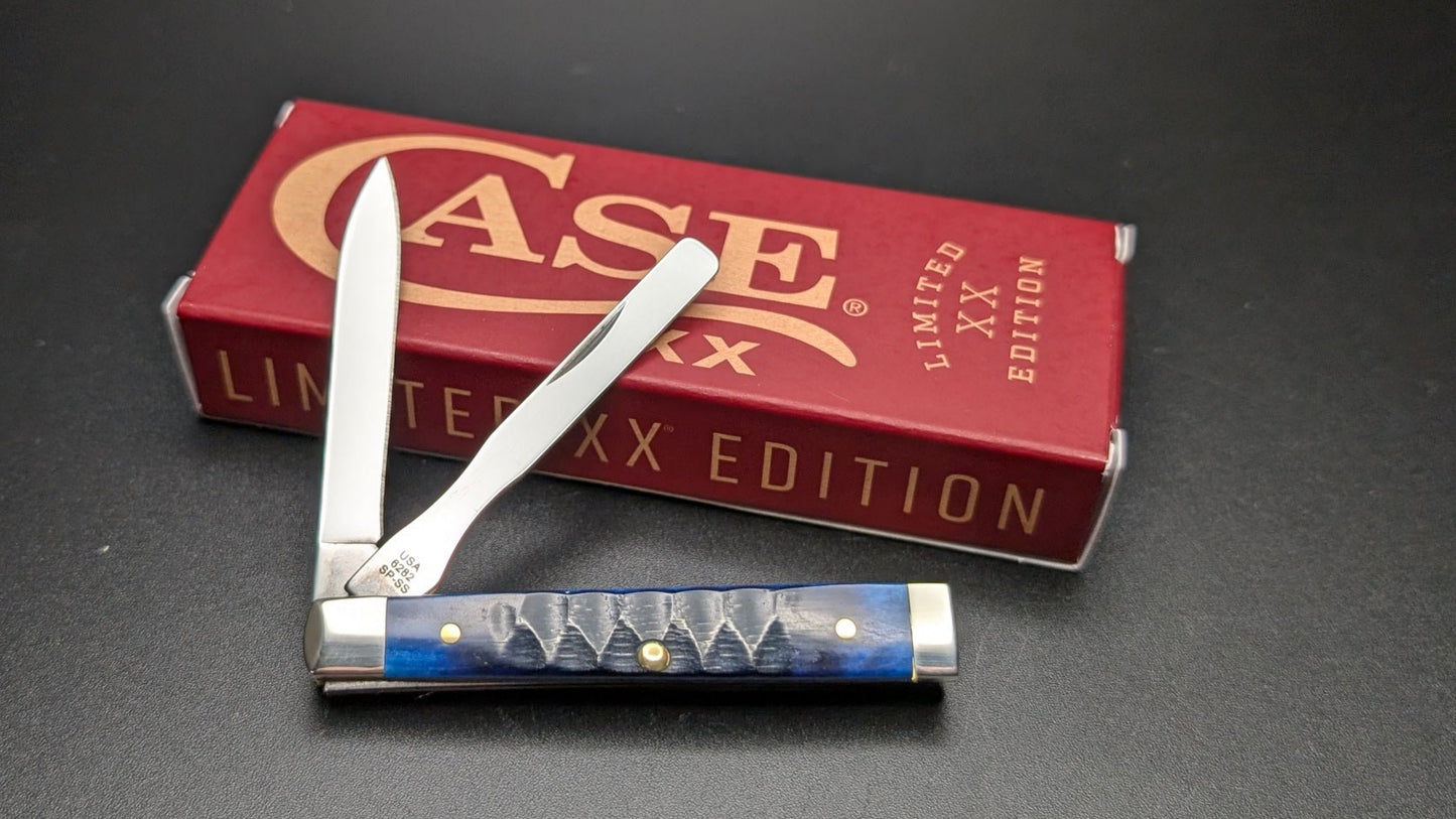 Folding knife with blue handle and Case brand box on a dark surface