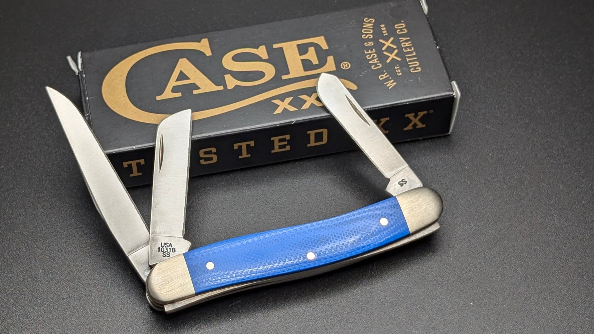 Case Blue G10 Smooth Medium Stockman Model #16752 Pattern (10318 SS) back open with box on gray surface