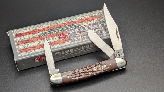 Case Stockman Folding Knife Brown Delrin Handle 3 Blades on a drak gray surface