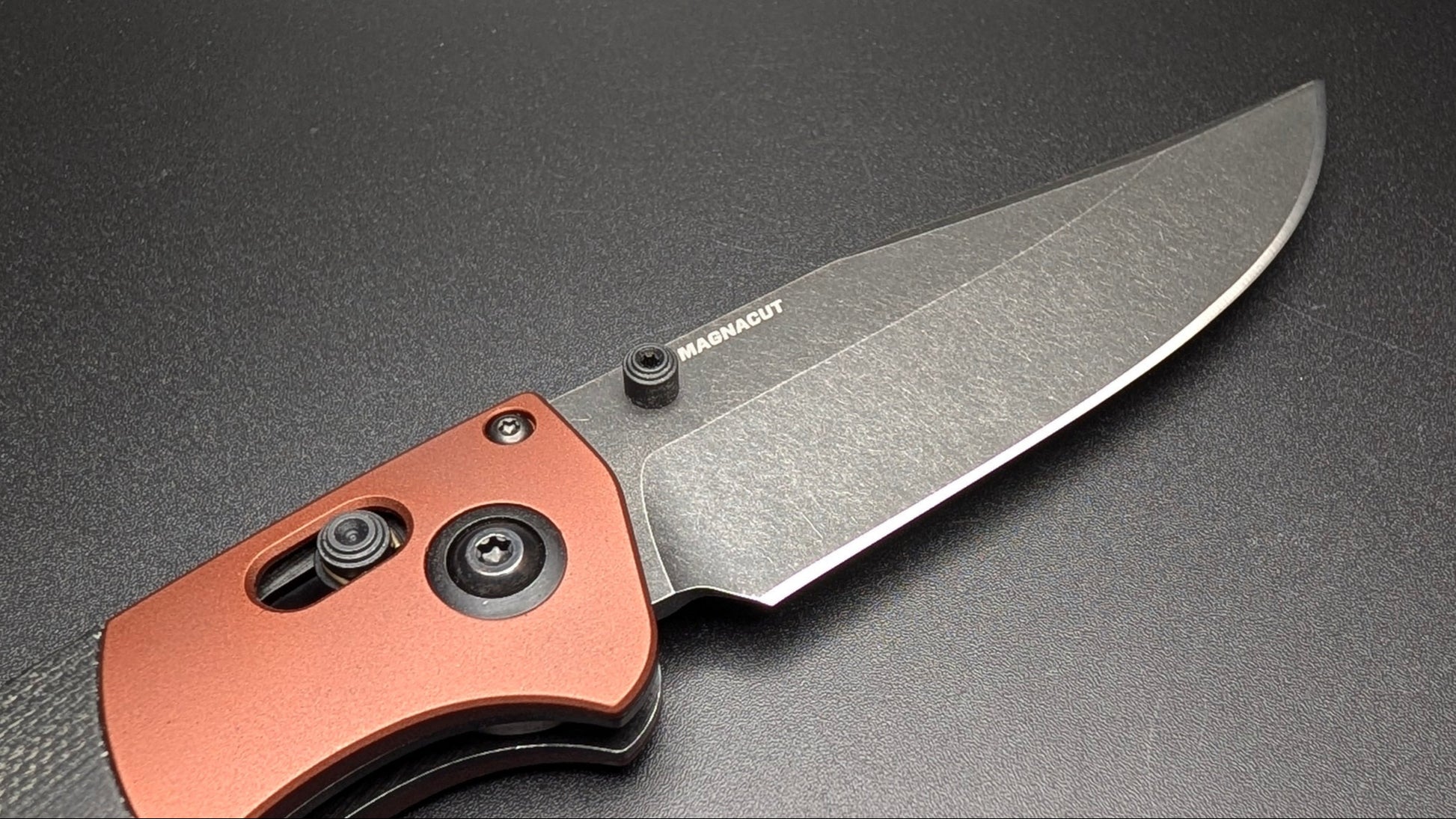 Folding knife with a copper handle on a black background