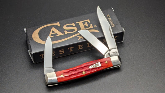 Case Indian Paint Brush Bone Kinfolks Jig Medium Stockman Model #42321 Pattern (63032 SS) on a drak gray surface open 3 blades