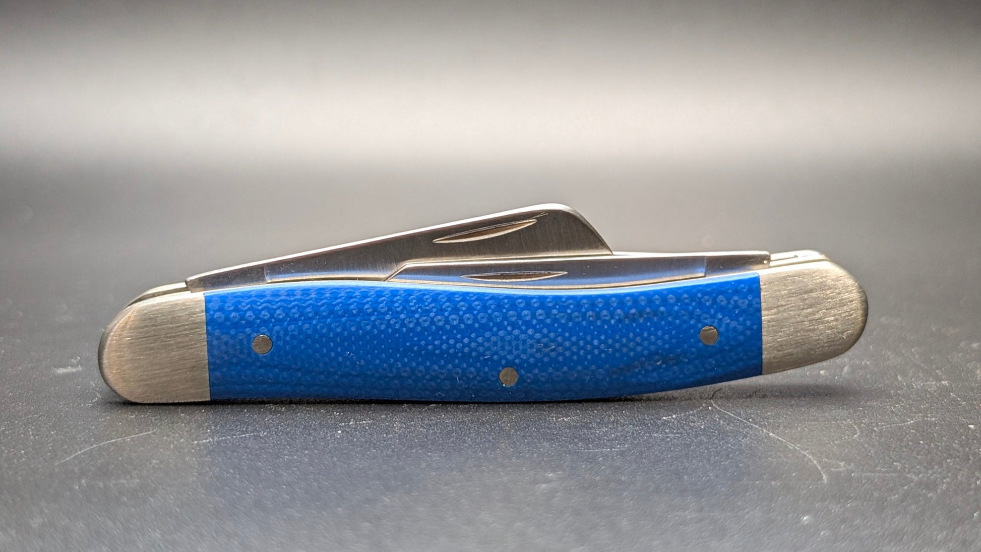 Case Blue G10 Smooth Medium Stockman Model #16752 Pattern (10318 SS) Closed Back on gray surface