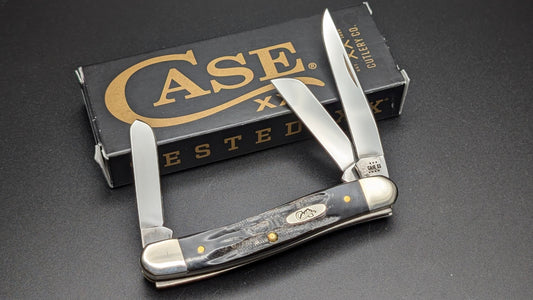 Case Buffalo Horn Jig Medium Stockman Model #66028 Pattern (BH318 SS) Open Front with box on gray surface
