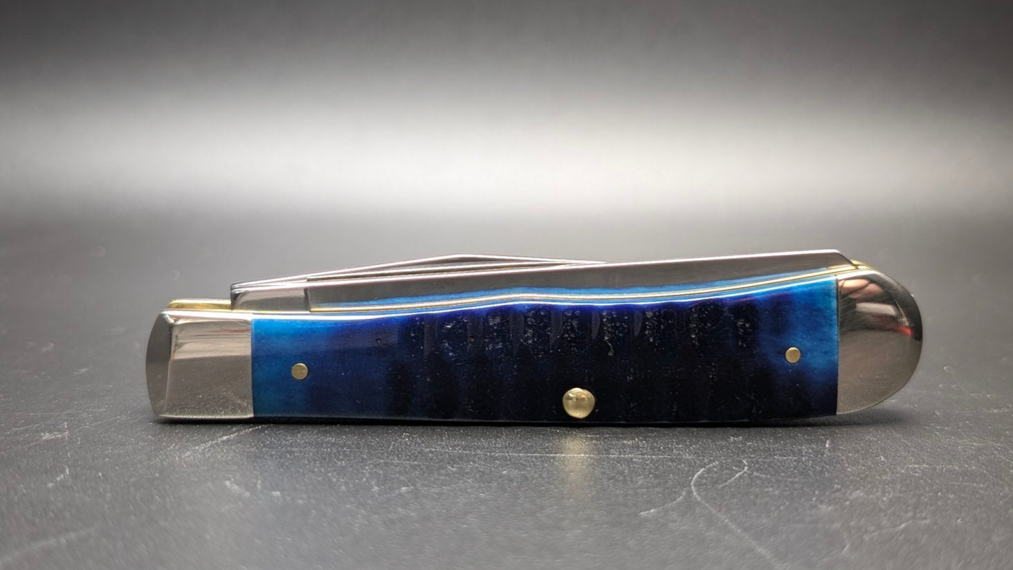 Blue pocket knife on a gray background