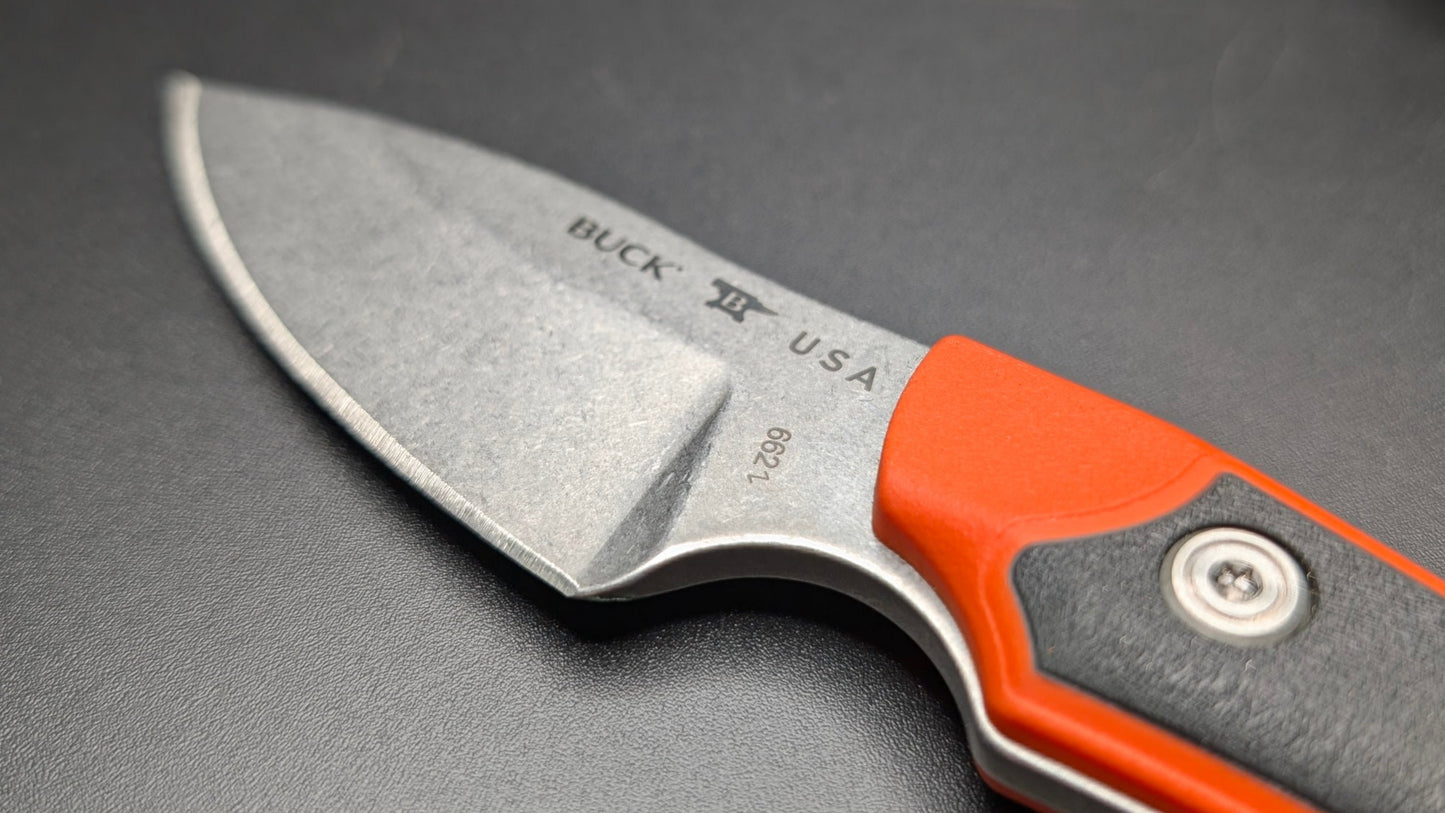 Fixed Blade knife with orange handle and 'Buck' branding on a gray background