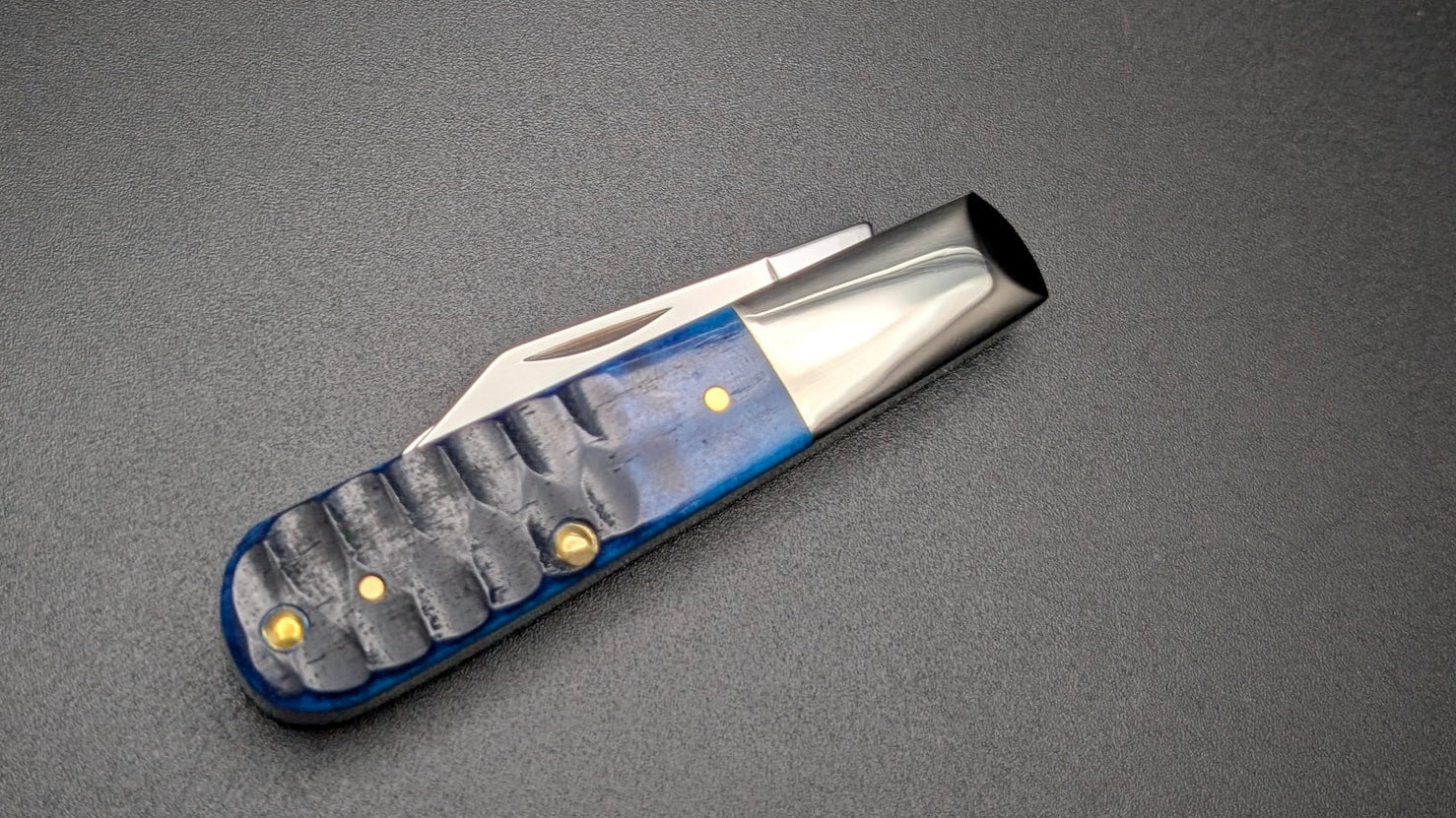 Knife with a blue handle on a dark gray background
