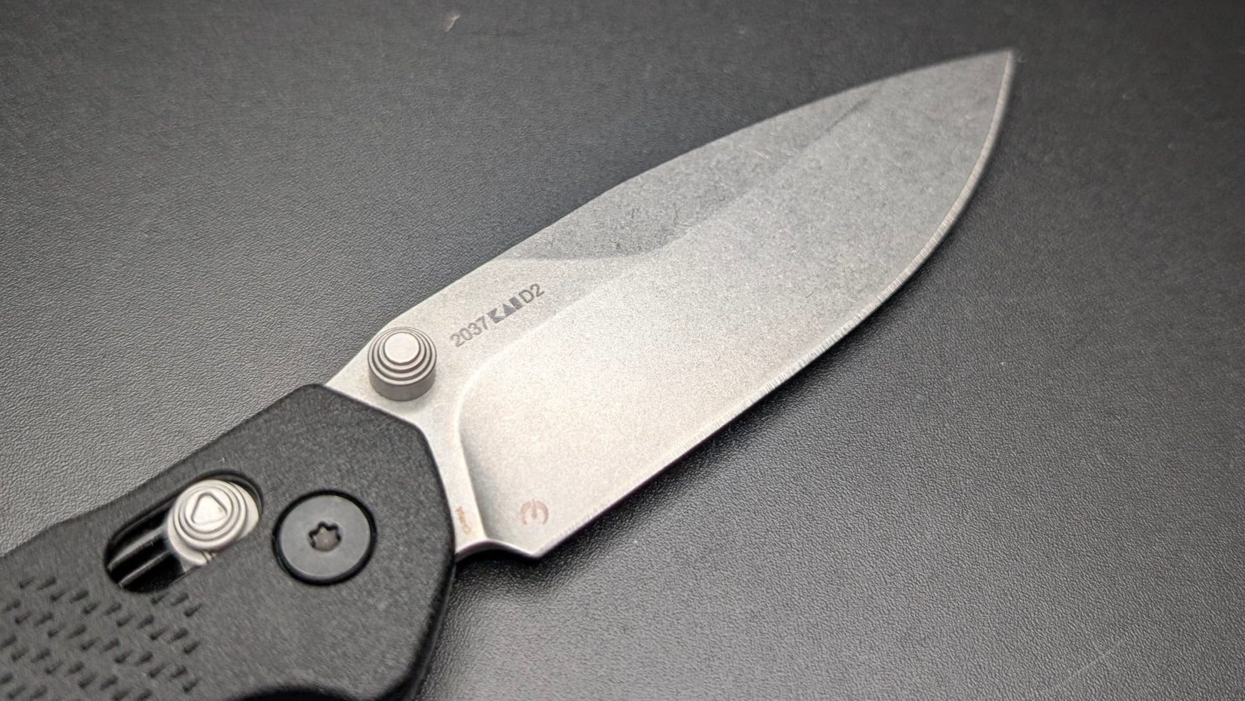 Folding knife on a dark surface