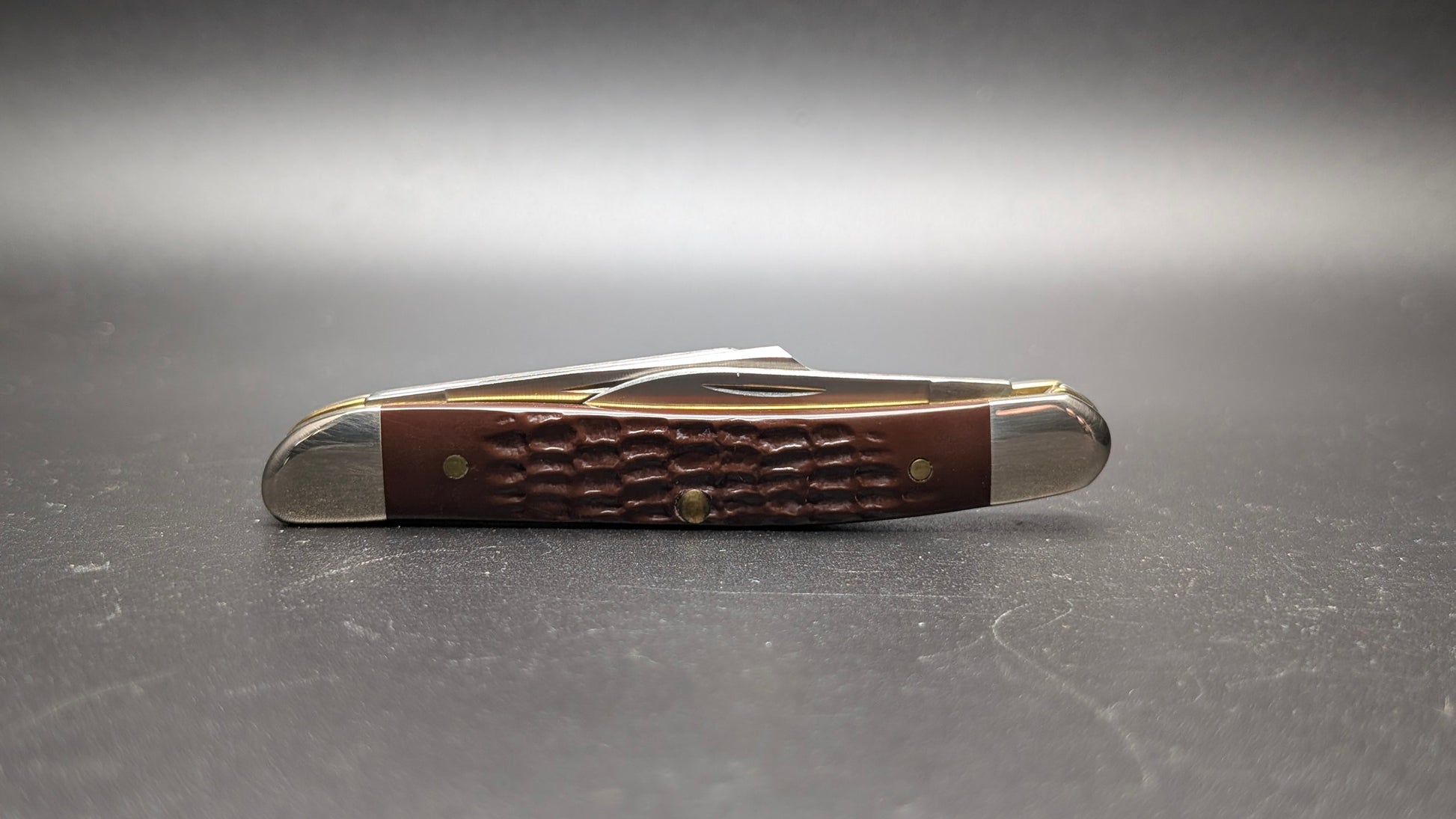 Delrin Brown Stockman Case Knife Back Closed on a dark gray surface