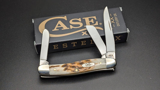 Case Amber Bone Peach seed Jig Medium Stockman Model #00042 Pattern (6318 SS) Open Front on a Gray Surface with Box