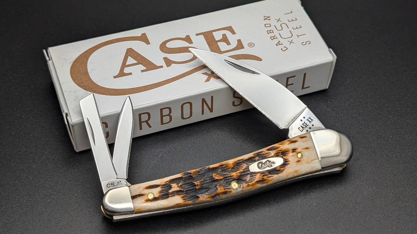 Case knife with Amber Bone handle on a dark surface with Case brand box in the background.