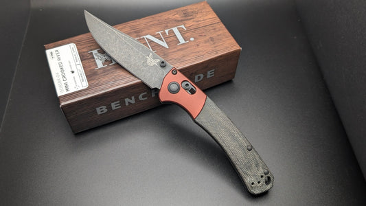 Folding knife with Hunt box on a dark surface
